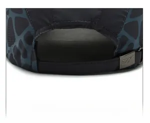 Detail of adjustable metal buckle and dark teal patterned fabric on quick-dry baseball cap