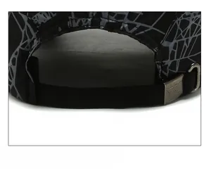 Close-up of adjustable metal buckle and breathable fabric on black sports baseball cap