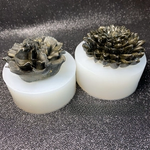 Detail view of 3D chrysanthemum silicone molds with finished resin flower display