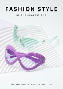 Detail of futuristic cat eye sunglasses featuring unique wavy texture frames and tinted lenses