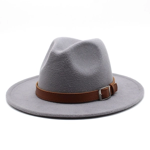 Detail of wool fedora hat featuring a brown leather strap and silver metal buckle accent