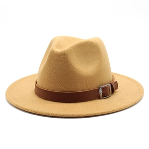 Detail of camel wool fedora hat with brown leather band and silver metal buckle