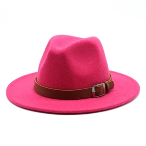 Magenta wool fedora jazz hat with brown leather belt and silver buckle on white background