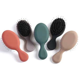 Mini massage hairbrushes with boar bristles and nylon pins in five matte finish colors