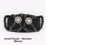 Detailed view of black magic hair comb with wooden beads and rhinestone flower accents