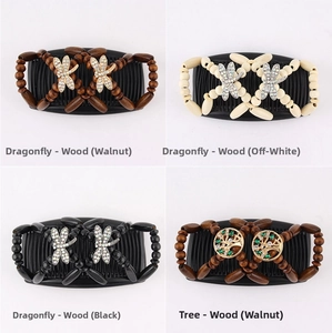 Detail of magic hair combs with dragonfly and tree metal charms and elastic wooden beads