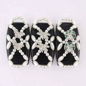 Detail of magic hair combs with white pearls, crystal butterflies, and tree of life motifs