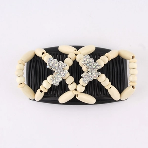 Detail view of wooden beads and sparkling crystal butterfly on double hair comb base
