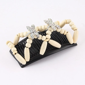 Detail of beaded magic hair comb featuring metallic dragonflies and rhinestone accents