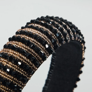 Close-up of handmade baroque headband with black faceted beads and gold micro beads