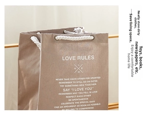 Close-up of Love Rules letter print on cotton rope canvas storage bag with metal eyelets