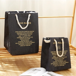 Two sizes of denim tote bags with thick cotton ropes and LOVE RULES gold lettering