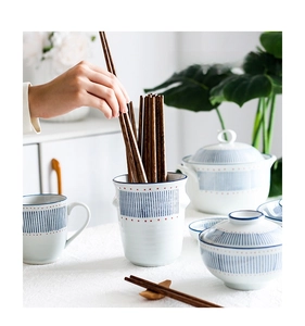 Macro detail of Japanese-style ceramic tableware with blue stripes and red dots patterns