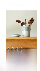 Detail of hand-painted Japanese ceramic cutlery holder with blue stripes and red dots