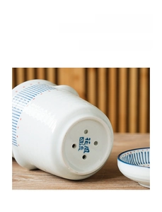 Detail of Japanese ceramic chopstick holder with four drainage holes and water collection tray