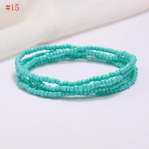 Detail of bohemian multilayer turquoise seed bead waist chain on white background