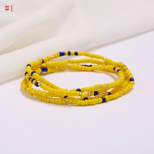 Close-up of layered handmade yellow and blue seed bead beach waist chain with gold spacers
