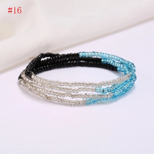 Detailed macro view of multi-layer beaded beach belly chains in blue and black colors