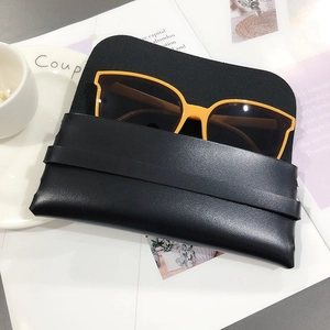 Bright yellow sunglasses with dark lenses and a black pebbled leather storage pouch