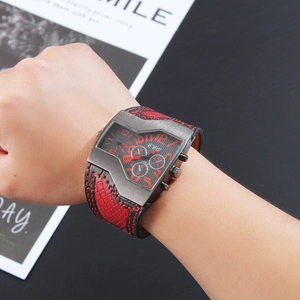 Detail of CCQ men's dual-movement watch with dark grey case and red leather strap on wrist