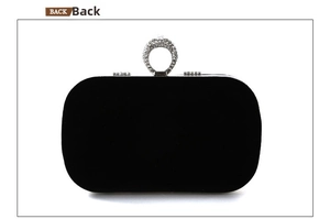 Rear view of black velvet evening clutch with sparkling rhinestone metal ring handle