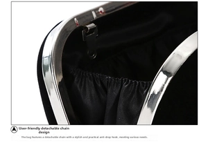 Close-up of detachable silver chain strap and secure metal hook for evening clutch bag