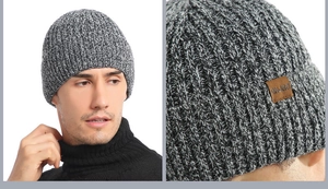 Detail of ribbed knit beanie in mixed grey showing leather patch and thick texture
