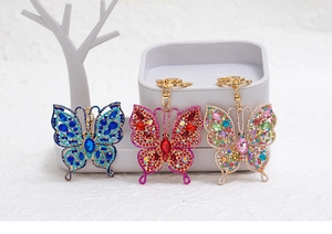 Detailed macro of rhinestone butterfly keychains in blue, red and multi-color crystals