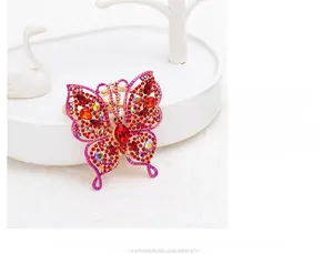 Macro view of crystal butterfly keychain featuring red rhinestones and golden hollow wings