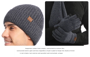 Detailed texture of thick ribbed knit scarf and touchscreen gloves in dark grey marl yarn