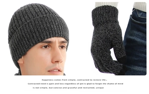 Detail of ribbed knit beanie and touchscreen gloves with thick yarn texture for winter