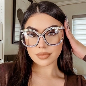 Detail of oversized diamond glasses frame with double-row rhinestones on female model