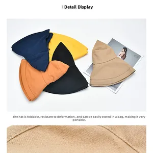 Detail of foldable breathable cotton sun hats in navy, yellow, black, orange, and beige
