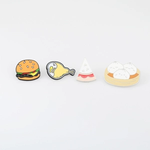 Detailed set of four cartoon food enamel pins featuring burgers, cake and dumplings