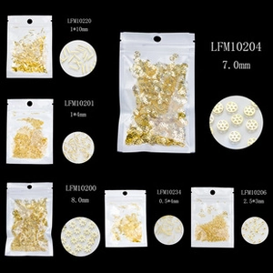 Macro detail of various golden alloy nail art charms and shapes for DIY manicure