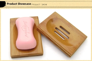 Bamboo soap dish set with drainage slots showing pink soap on a natural wood holder