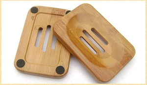 Detail of bamboo soap dish showing drainage holes and non-slip pads on the back