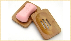 Detail showing the drainage holes and wood grain of the bamboo soap dish tray