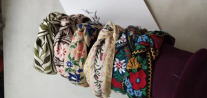 Close-up of bohemian knot headbands with detailed floral embroidery in multiple colors