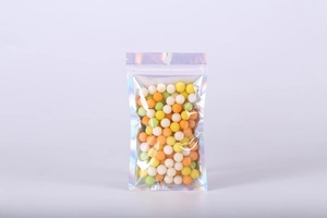 Detailed view of iridescent holographic seal bag filled with colorful candies