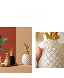 Macro detail of resin pineapple decor showing realistic texture and gold leaves