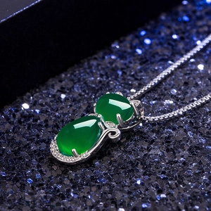 Elegant green agate cat pendant necklace in silver plating on dark starry background