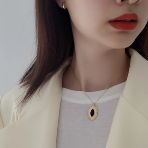 Detail view of vintage S925 silver necklace with black onyx marquise pendant on model