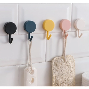 Rotating 3-branch adhesive wall hooks in various colors shown on bathroom tile wall