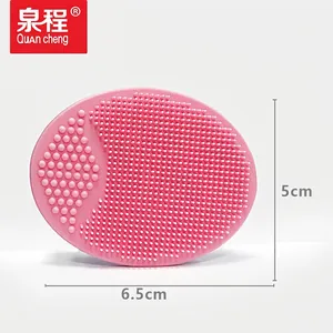 Pink silicone face cleansing brush massager with dual-texture bristles measuring 6.5x5cm