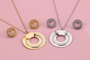 Detail view of gold and silver plated jewelry sets featuring rhinestone inlaid C-shape pendants