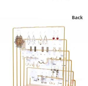 Detail view of the four-tier gold metal frame and wood base earring jewelry rack back view