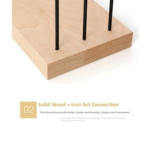 Close-up of a solid wood base and black iron rod connection for a jewelry organizer stand