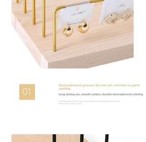 Close-up of golden iron jewelry rack with smooth electrophoretic finish and wood base