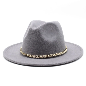 Detail of grey wool fedora hat featuring golden chain and white pearl embellishments